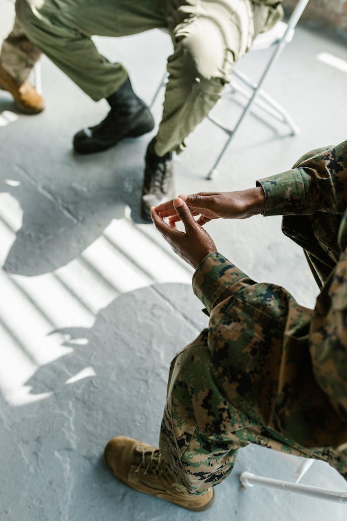 services-02 Soldiers engage in group therapy, fostering support and mental health in an indoor setting.
